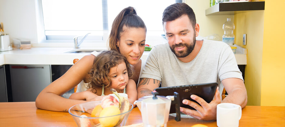 family checking something on tablet image
